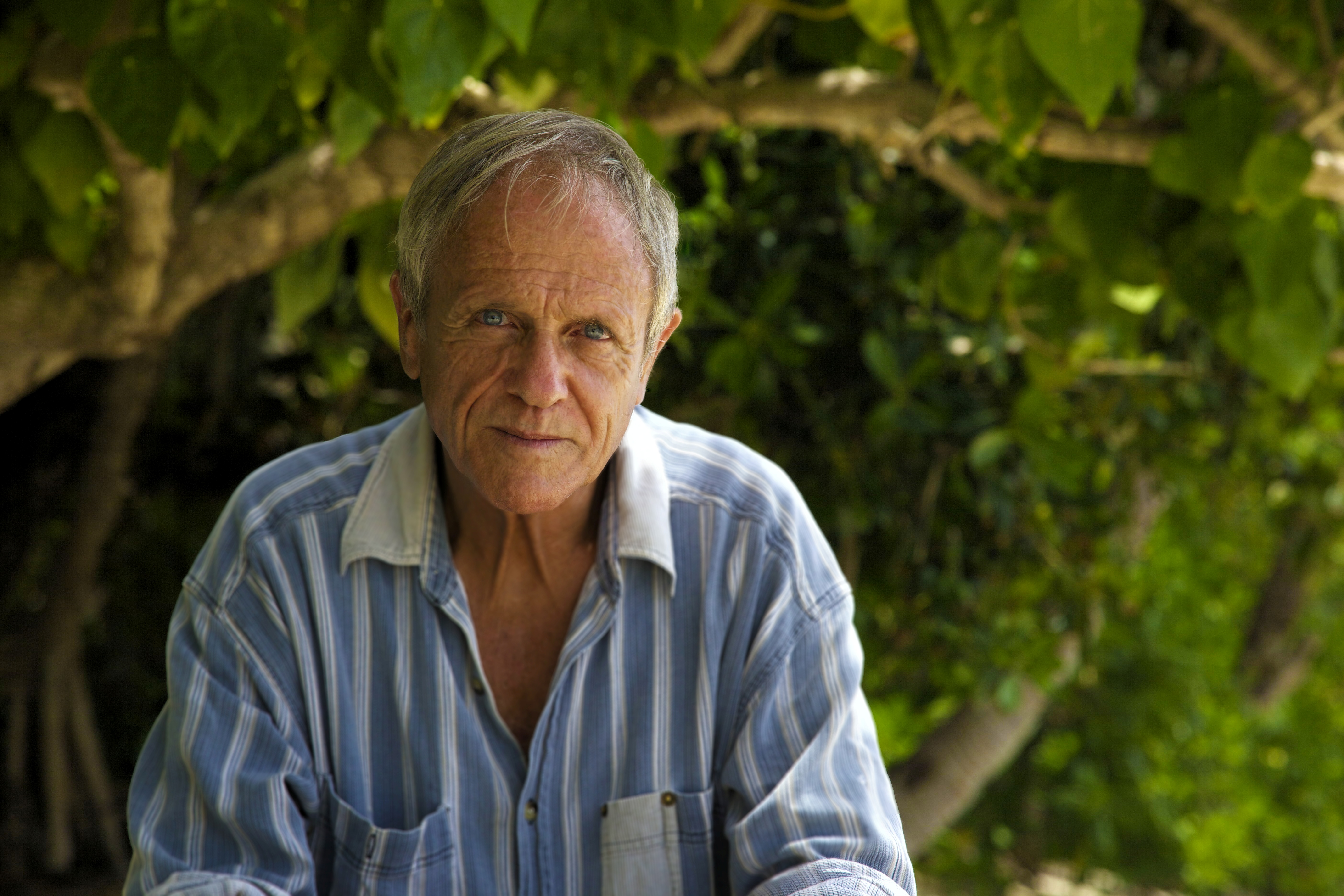 A Picture of Charlie Veron in front of a leafy background
