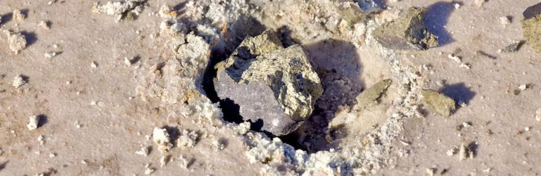 Meteorite sitting in the sand at Lake Hope