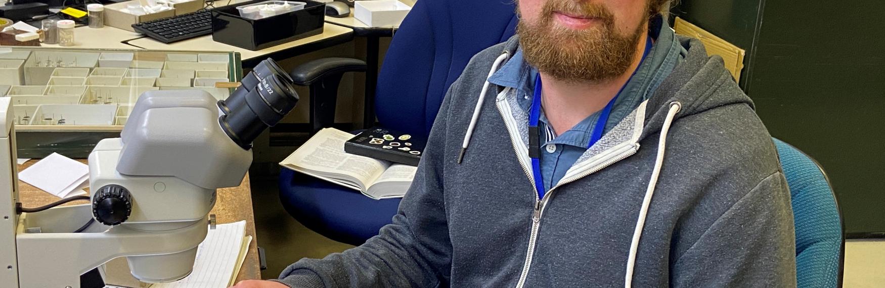 Stuart Lay sitting at a desk doing research