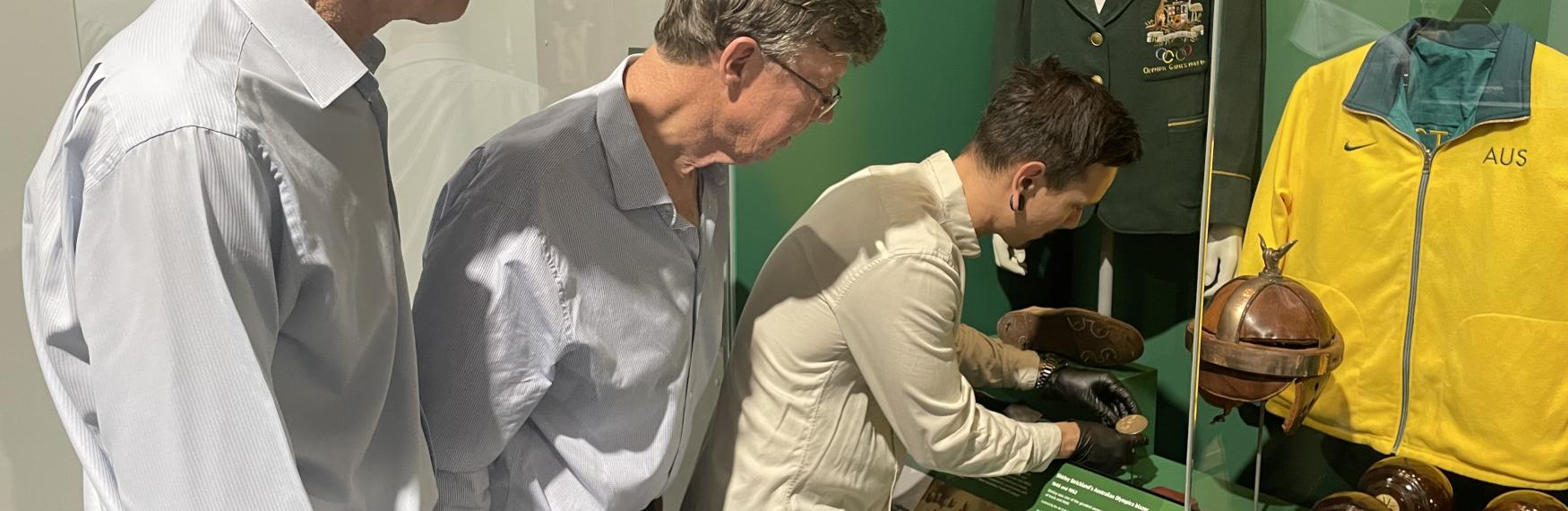 Peter and Chris Winter with Cahn Campion installing the John Winter Gold Medal in the Reflections Gallery at WA Museum Boola Bardip.