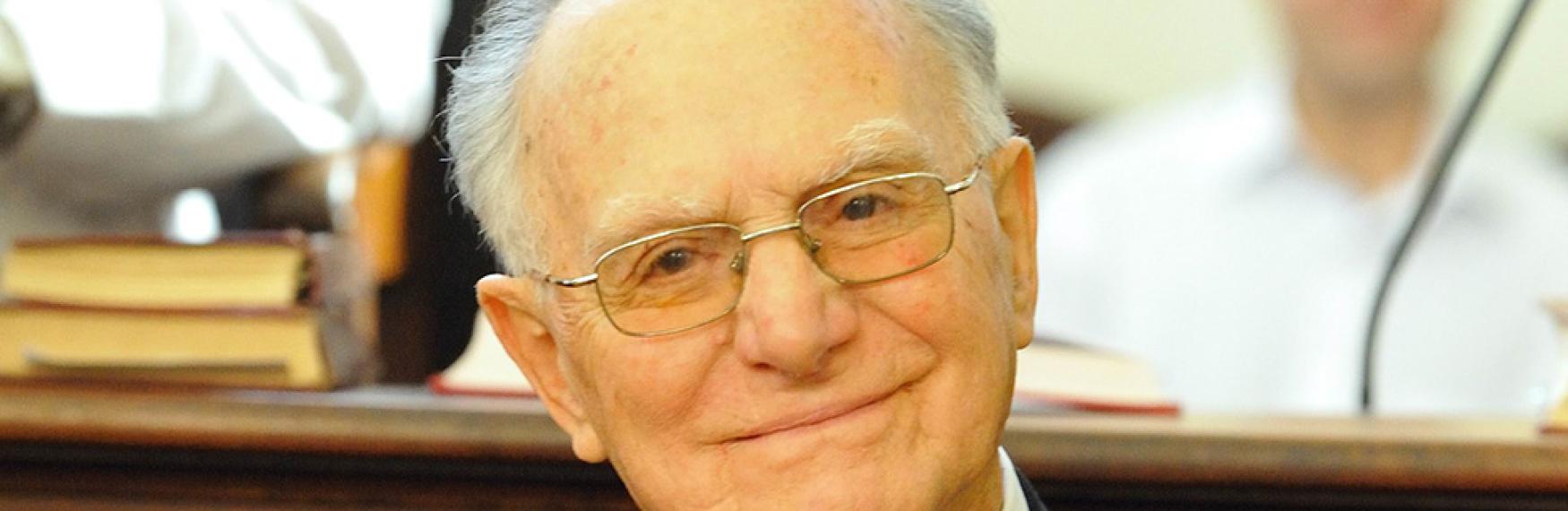 An older man in a black suit