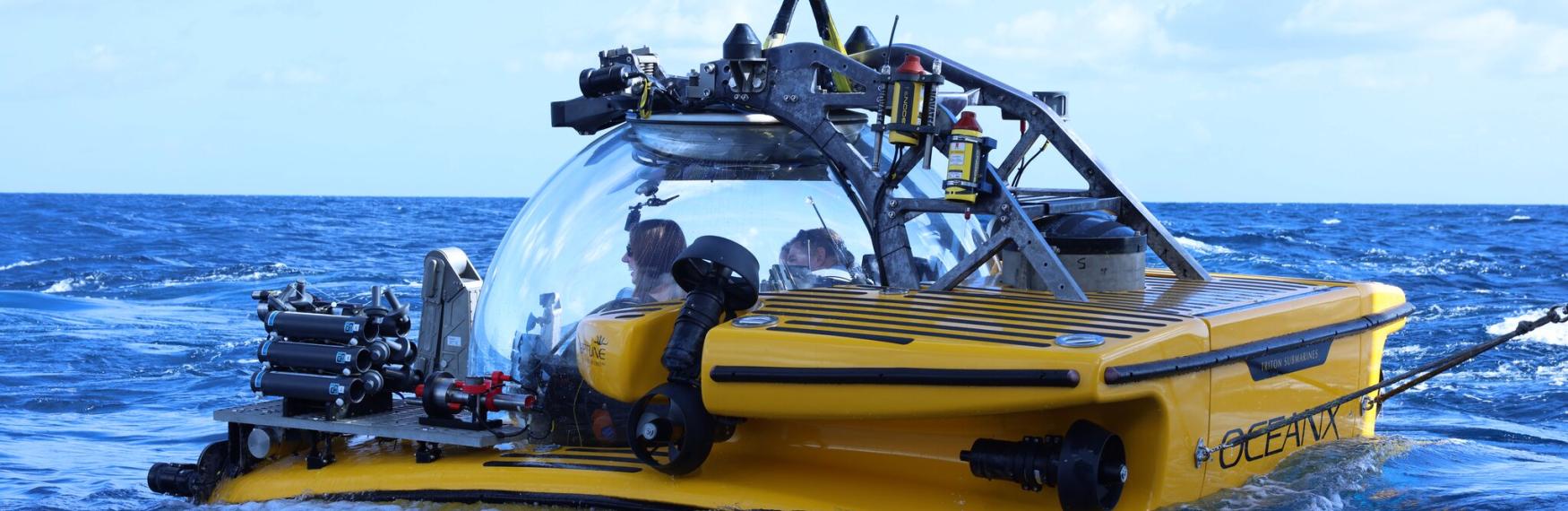 A yellow submersible sitting in water
