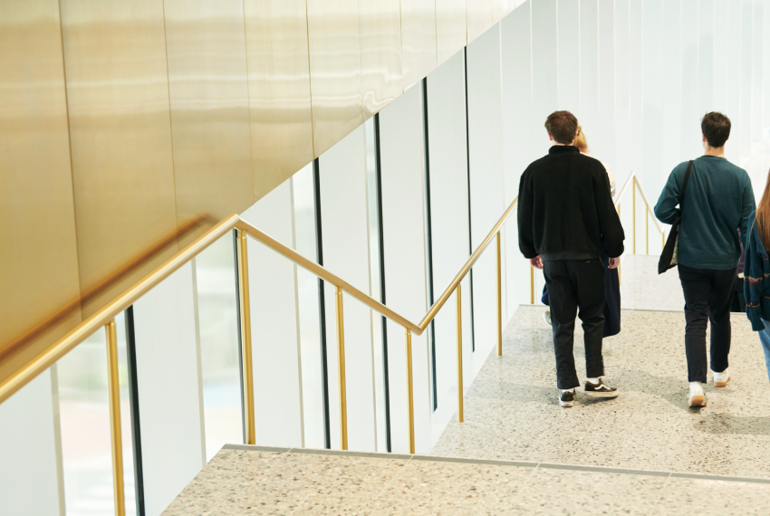 Two people walking down a staircase