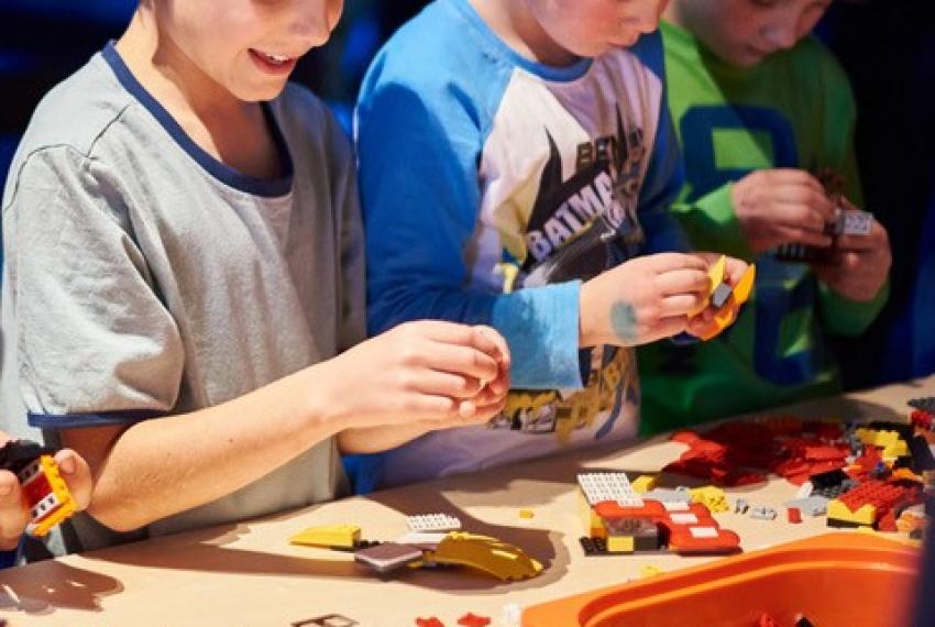 A group of children build LEGO models