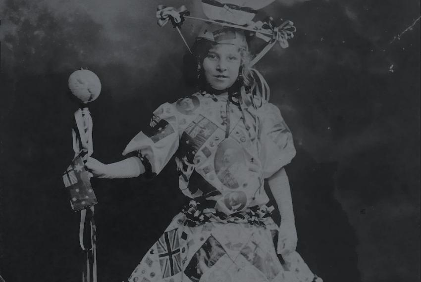 Girl wearing dress with hat that looks resembles a world globe