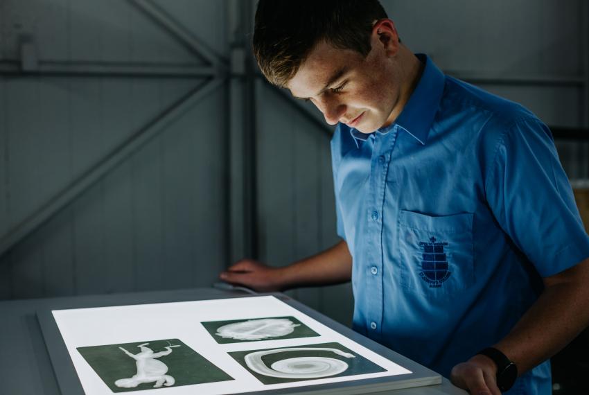 A young person looking at images on a lightbox