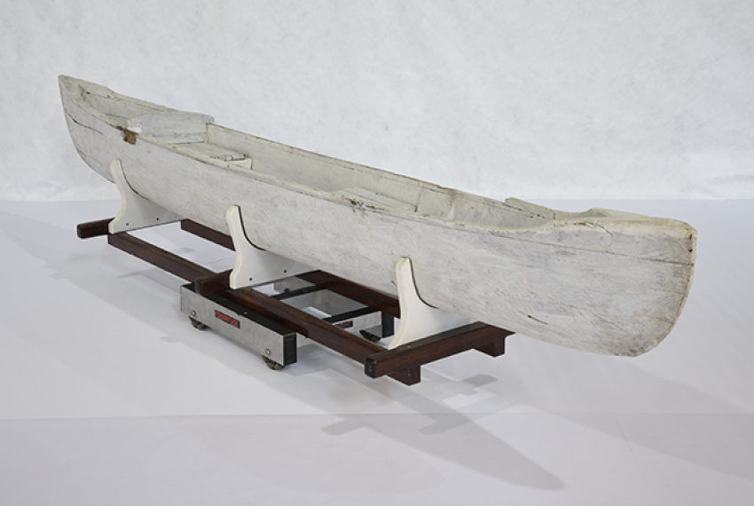 This double outrigger canoe was likely constructed from a single piece of hollowed Gyrocarpus Americanus wood and painted white. It comes with two booms, to which two floats can be attached. One float is broken. The vessel features two loose seats, one with a back rest. The floats are slipped in metal stirrups and wired on. 