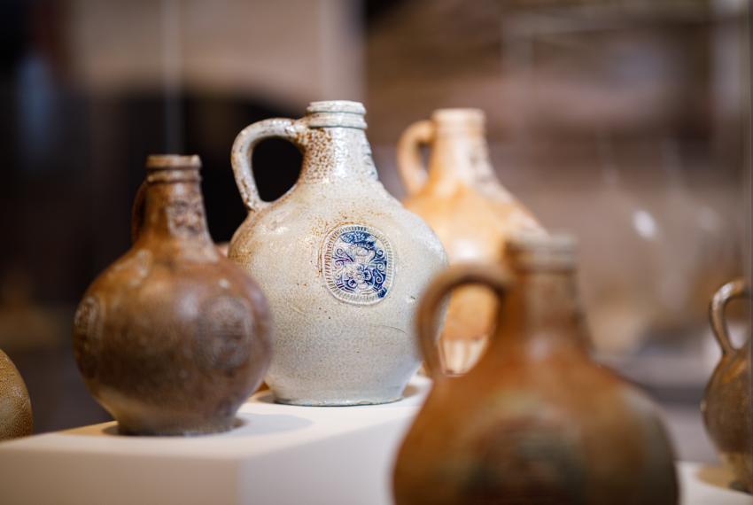 Collection of beige and brown vases with handles