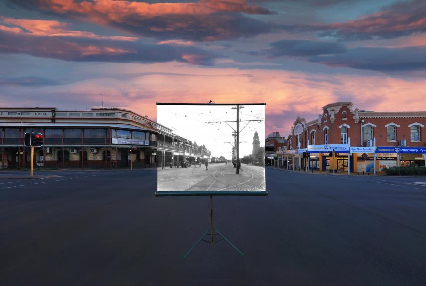 A street intersection with a screen in the middle of the street displaying old section