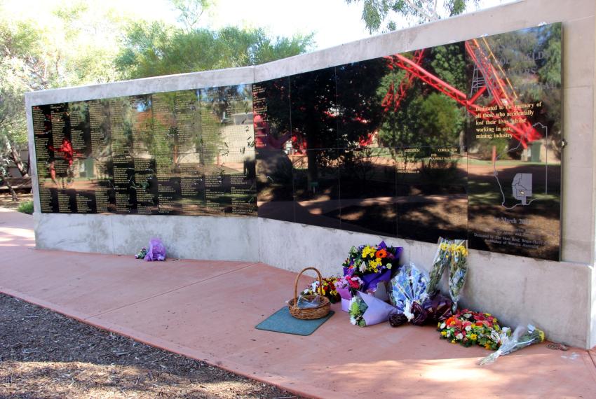 A large memorial with flowers at its base