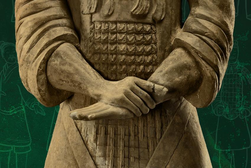 A terracotta warrior statue against a dramatic dark green background