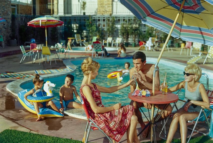 a scene of families lounging around a resort style pool 