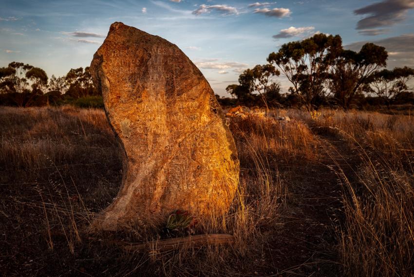 a stone on the land with engravings 