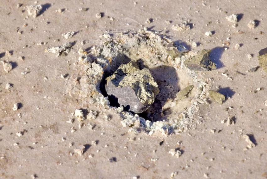 Meteorite sitting in the sand at Lake Hope