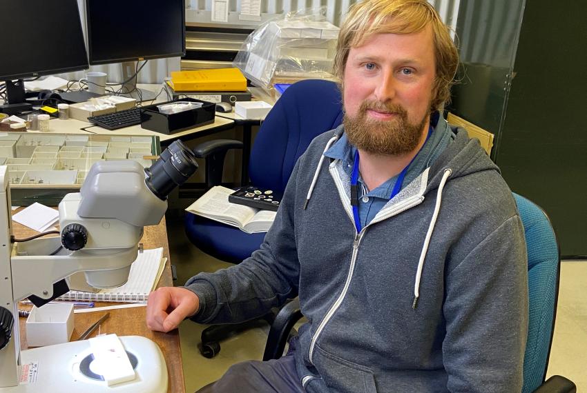 Stuart Lay sitting at a desk doing research
