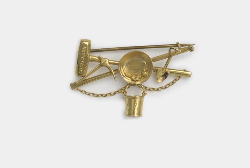Aronson & Co, Coolgardie brooch c.1896. Gold brooch with mining tools.
