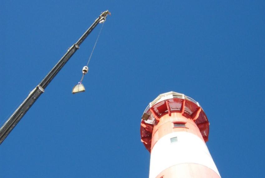 A crane removing the lens from the Port Moore lighthouse