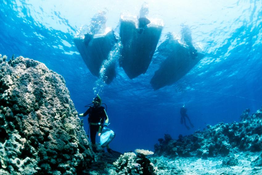 A diver leaping off a boat onto a Kimberley reef
