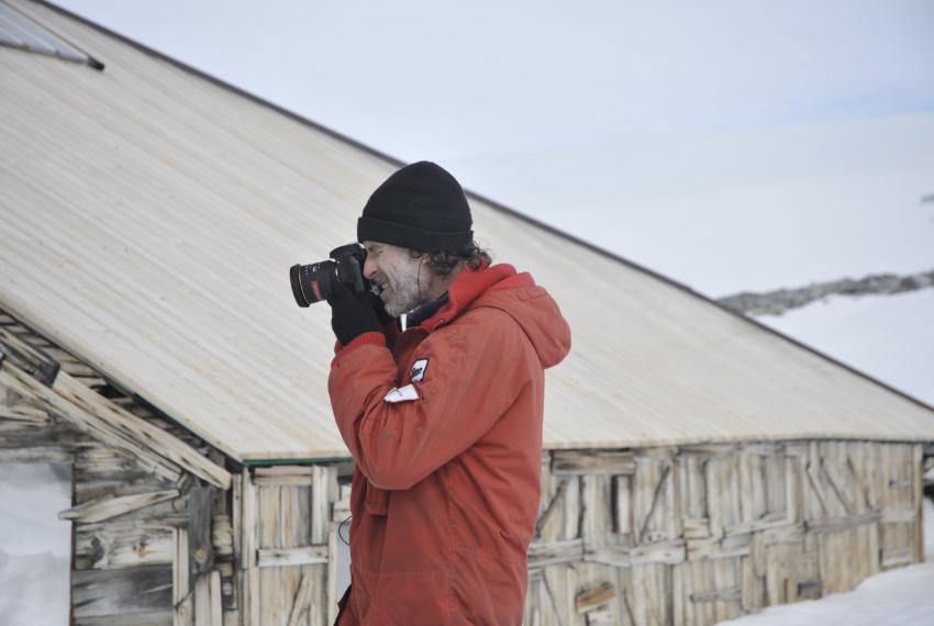 Ian Godfrey documenting the exterior fabric of Mawson's Main Hut at Cape Denison in 2012