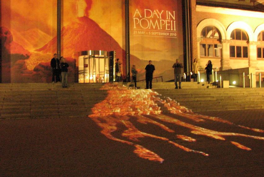 Projection of lava flowing over the steps to the entrance to the WA Museum