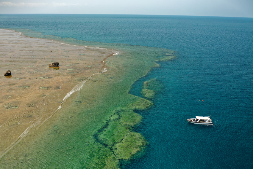 Dissected Reef with boat approaching on the water