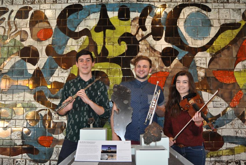 Jonty Coy, Fletcher Cox and Louise May pose around the meteorite display