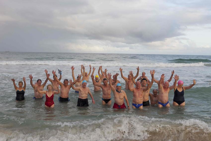 A large group of elderly people on the beach