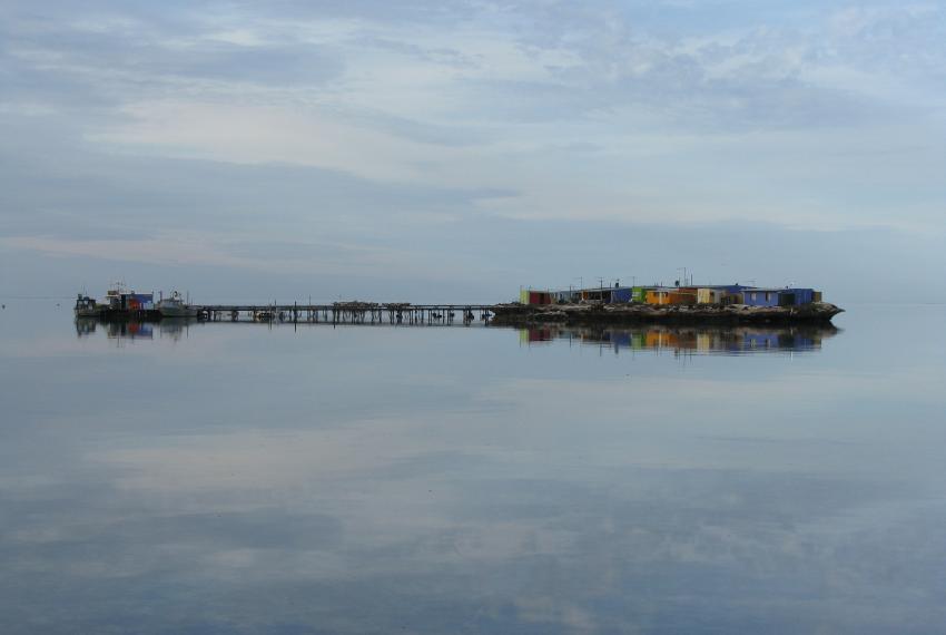 The Abrolhos Islands at a sunrise showing a reflection of the islands against the calm water