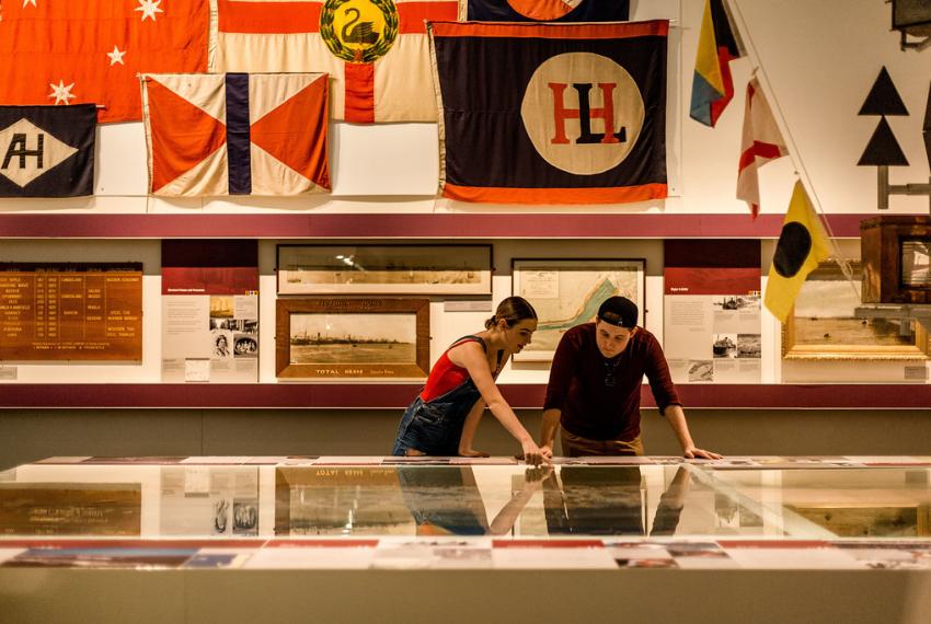 A young man and woman standing inside a WA Maritime Museum gallery