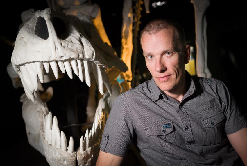 Dr Mikael Siversson, Western Australian Museum Curator of Palaeontology, next to a cast of a Tyrannosaurus Rex