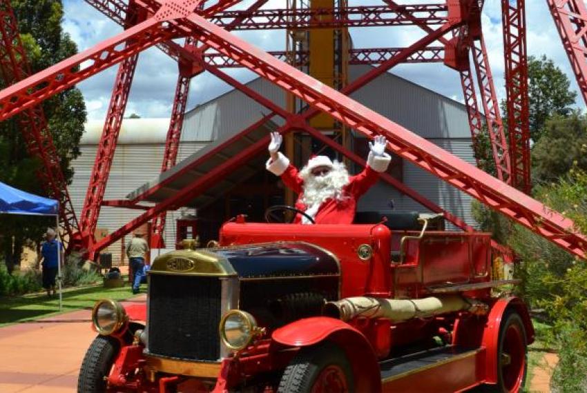Santa sitting in an old red car in Kalgoorlie