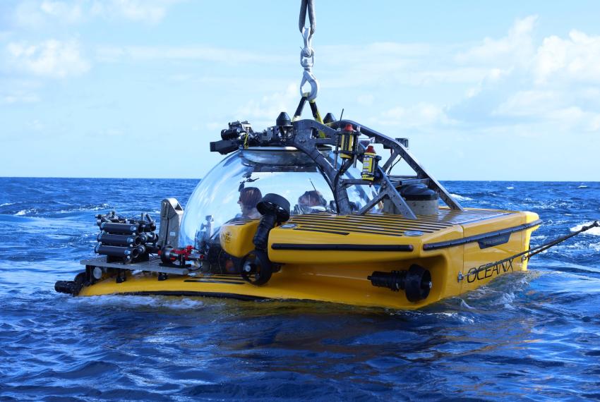 A yellow submersible sitting in water