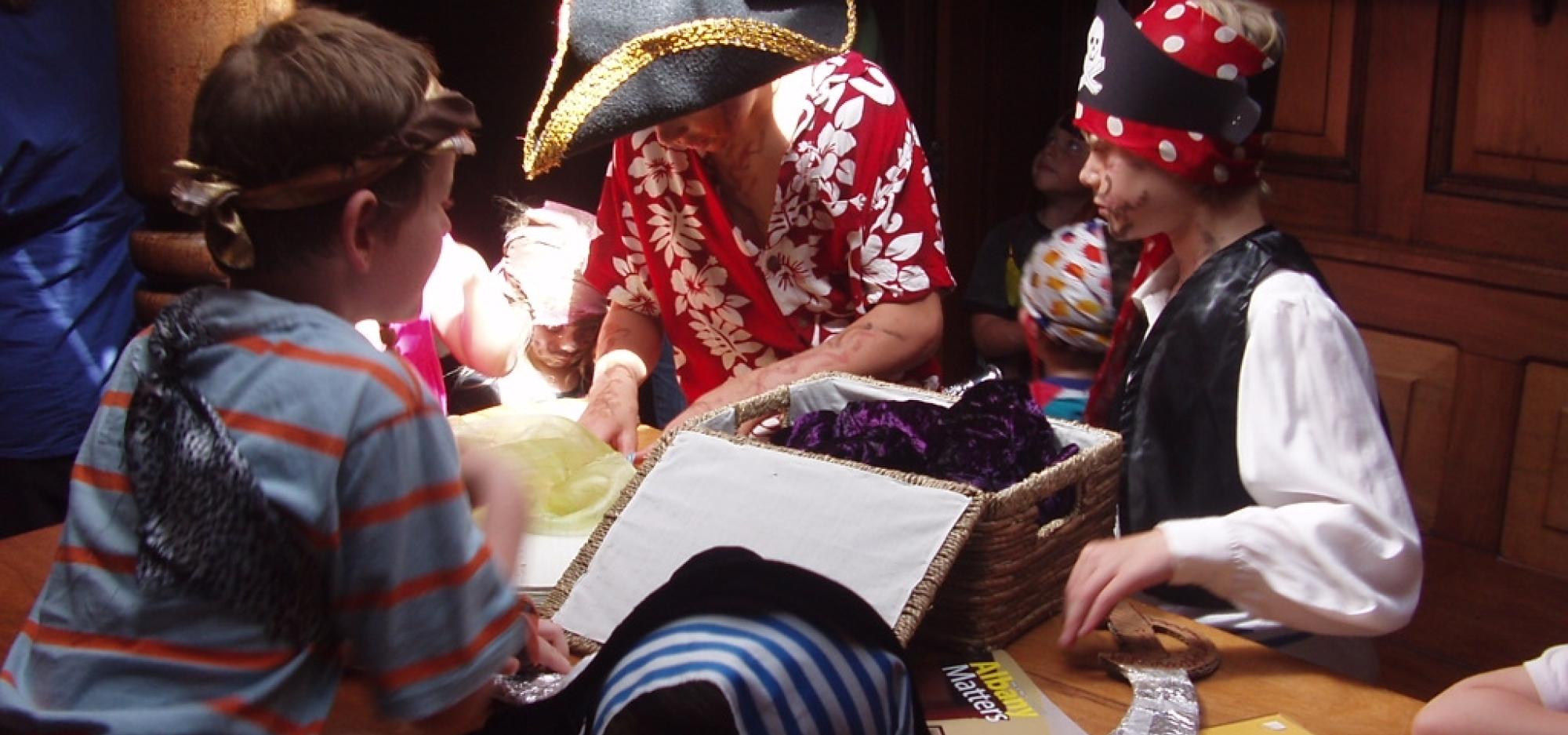 Three students dressed as pirates completing an education activity