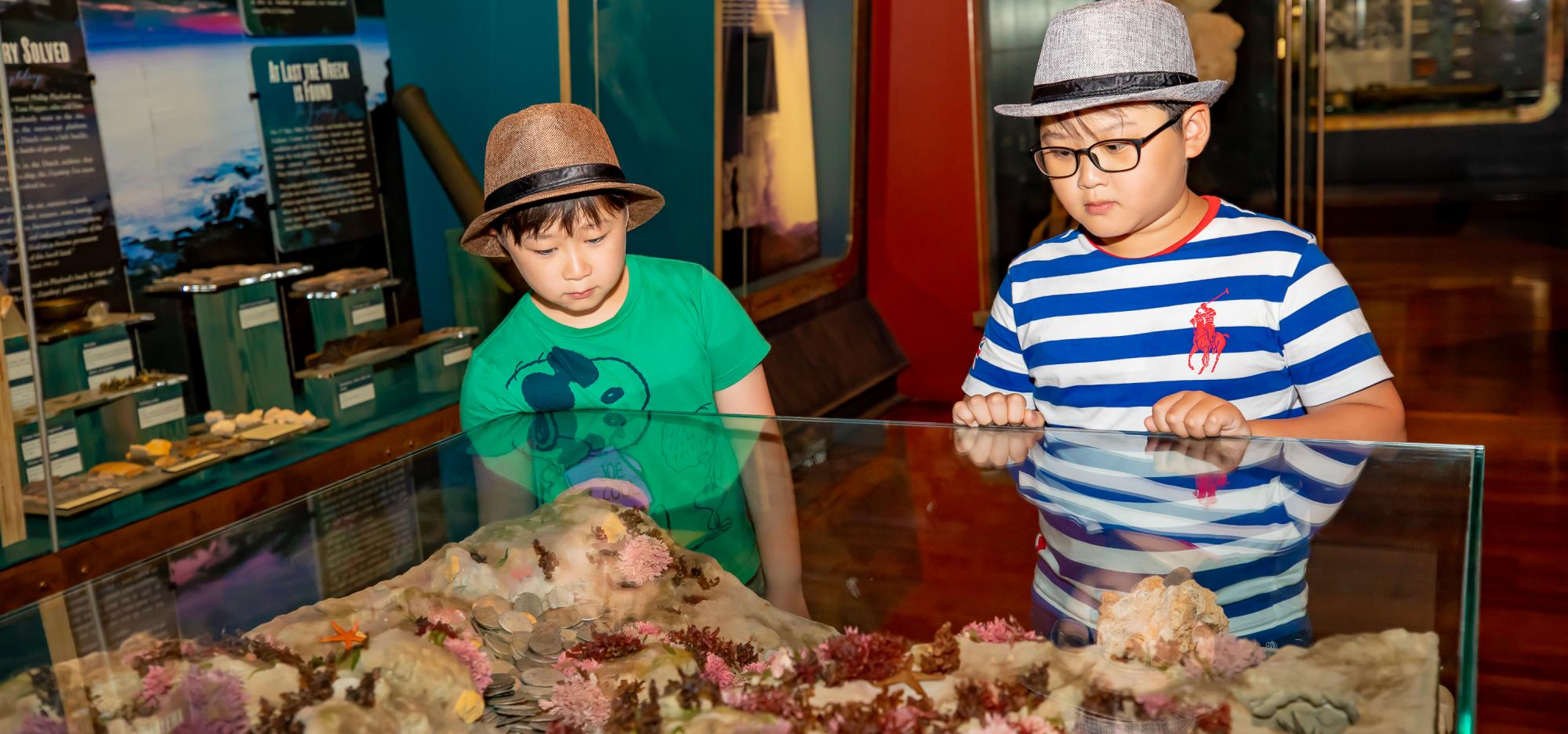 Two children look at a showcase in the Museum of Geraldton's Shipwrecks Gallery