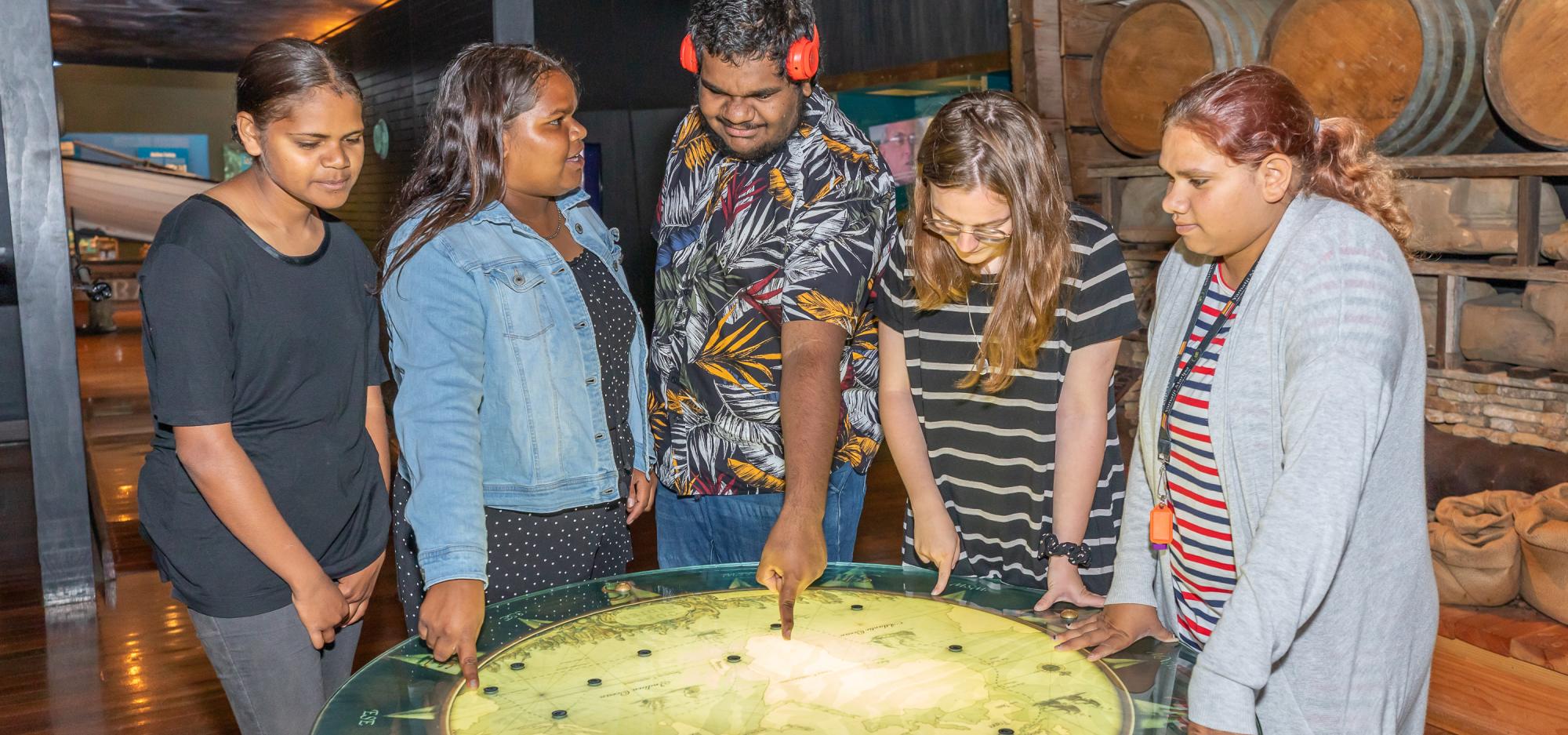 A group of young people use an interactive exhibit at the Museum of Geraldton