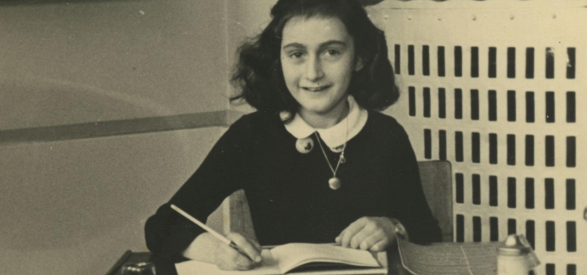 A photograph of a young girl sitting at a school desk