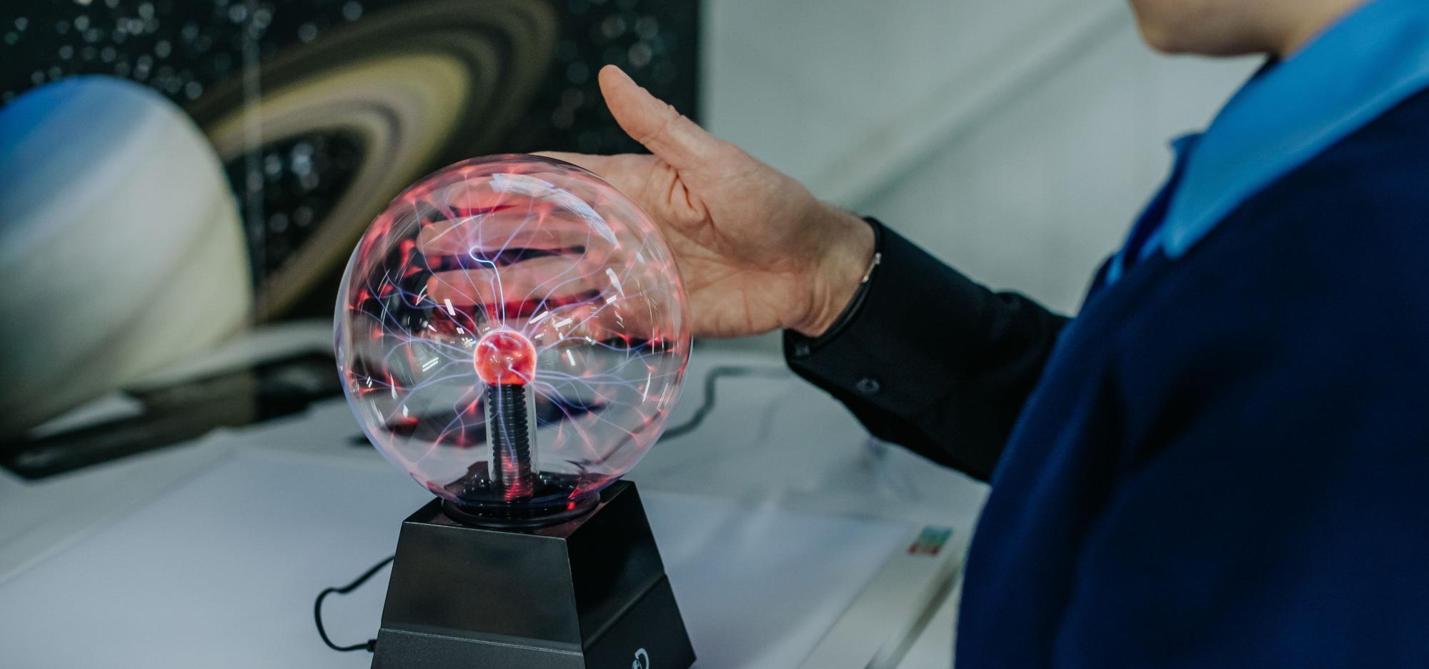 A child touching a sparky ball