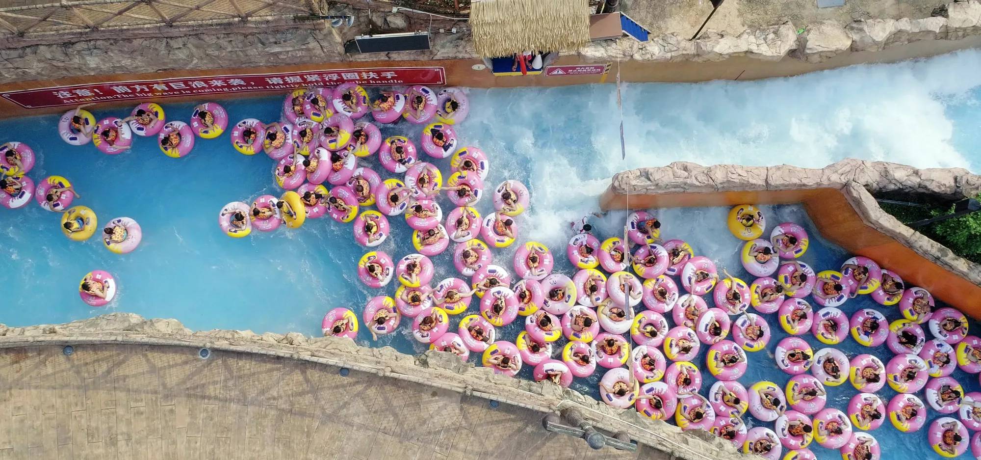 people in pink rubber rings in a river