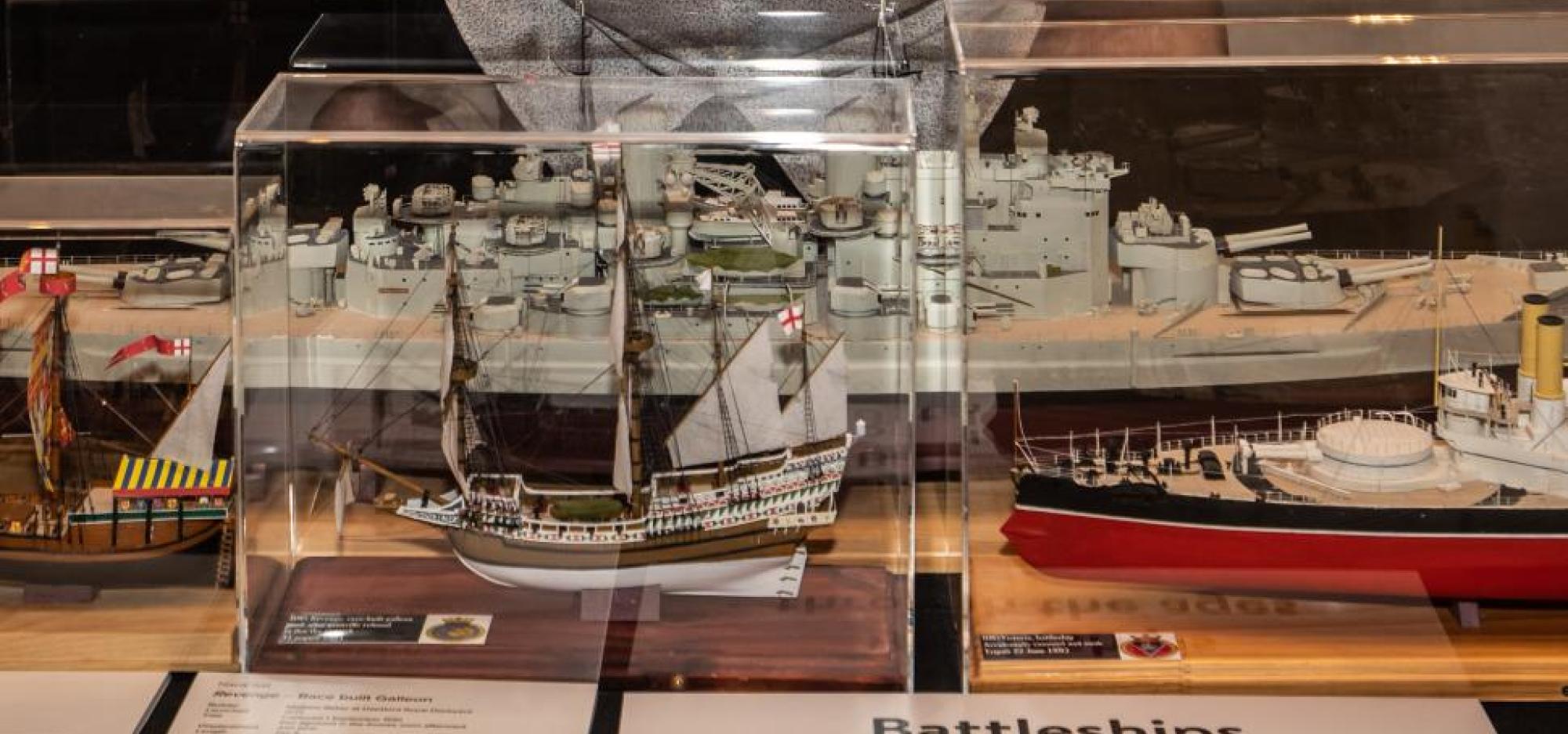 Gerry Westenberg with miniature ship model in glass case 