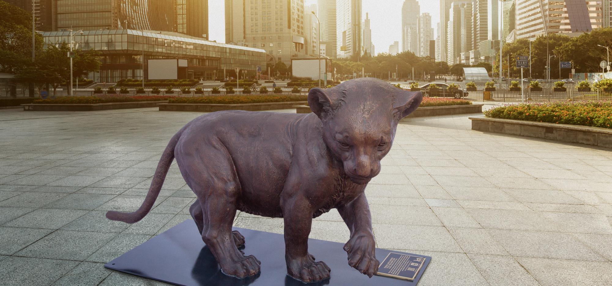 Wild Baby Lion statue in city setting