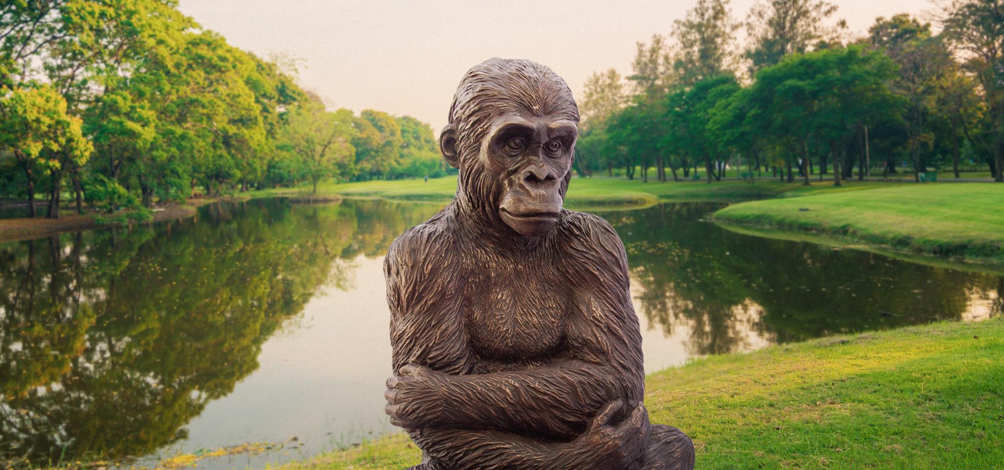 Wild Baby Western Lowland Gorilla statue on a green field