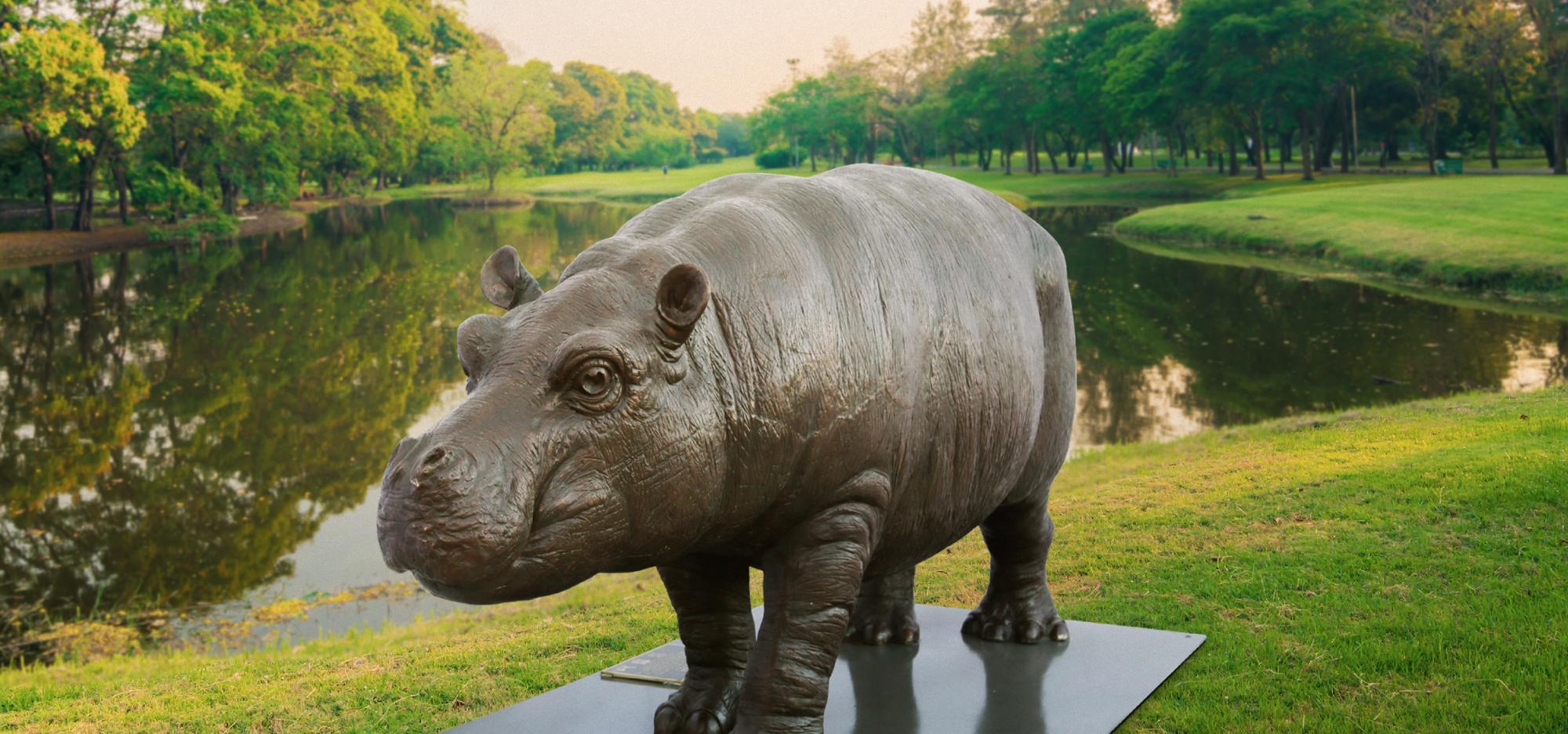 Wild Baby Hippo statue on green field