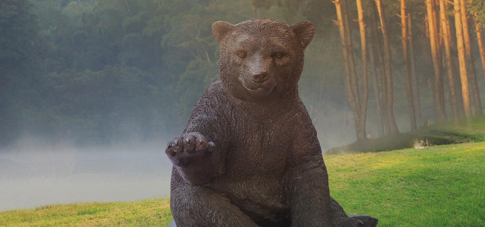 Wild Baby Polar Bear statue placed near a lake