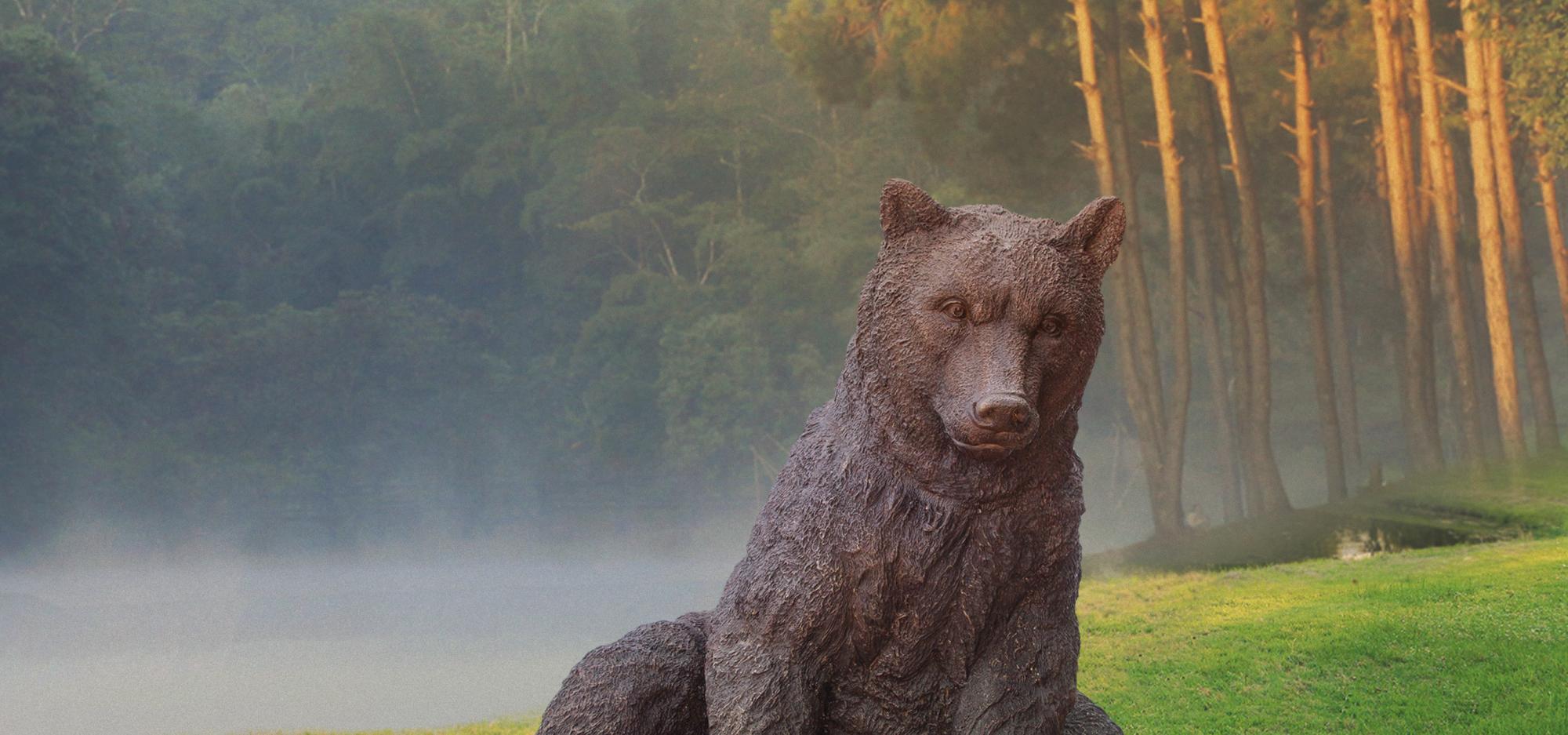 Marsican brown bear statue on greenery