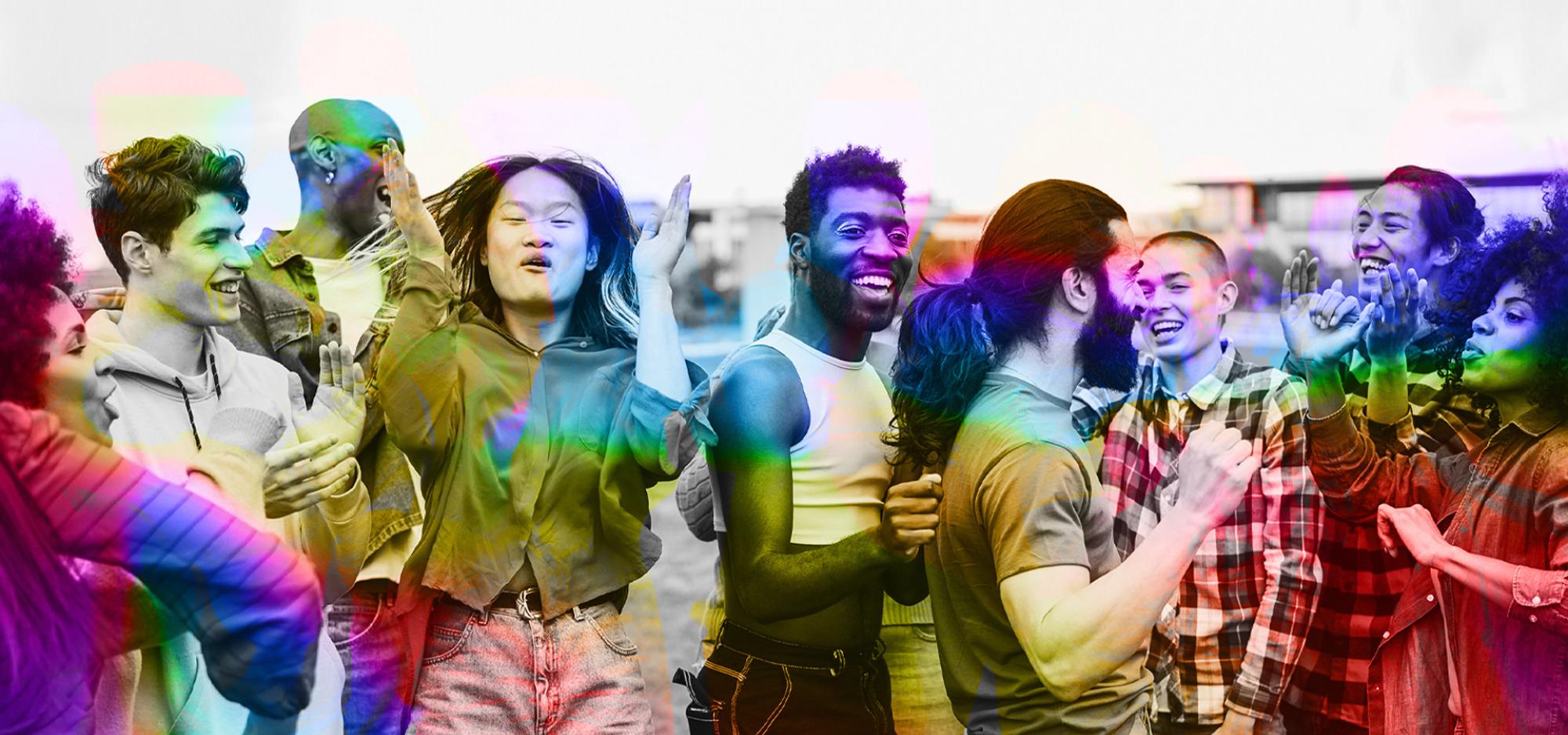A diverse group of young people having fun dancing outdoors, with a focus on the bearded man's face. The image is black and white but has colourful accents