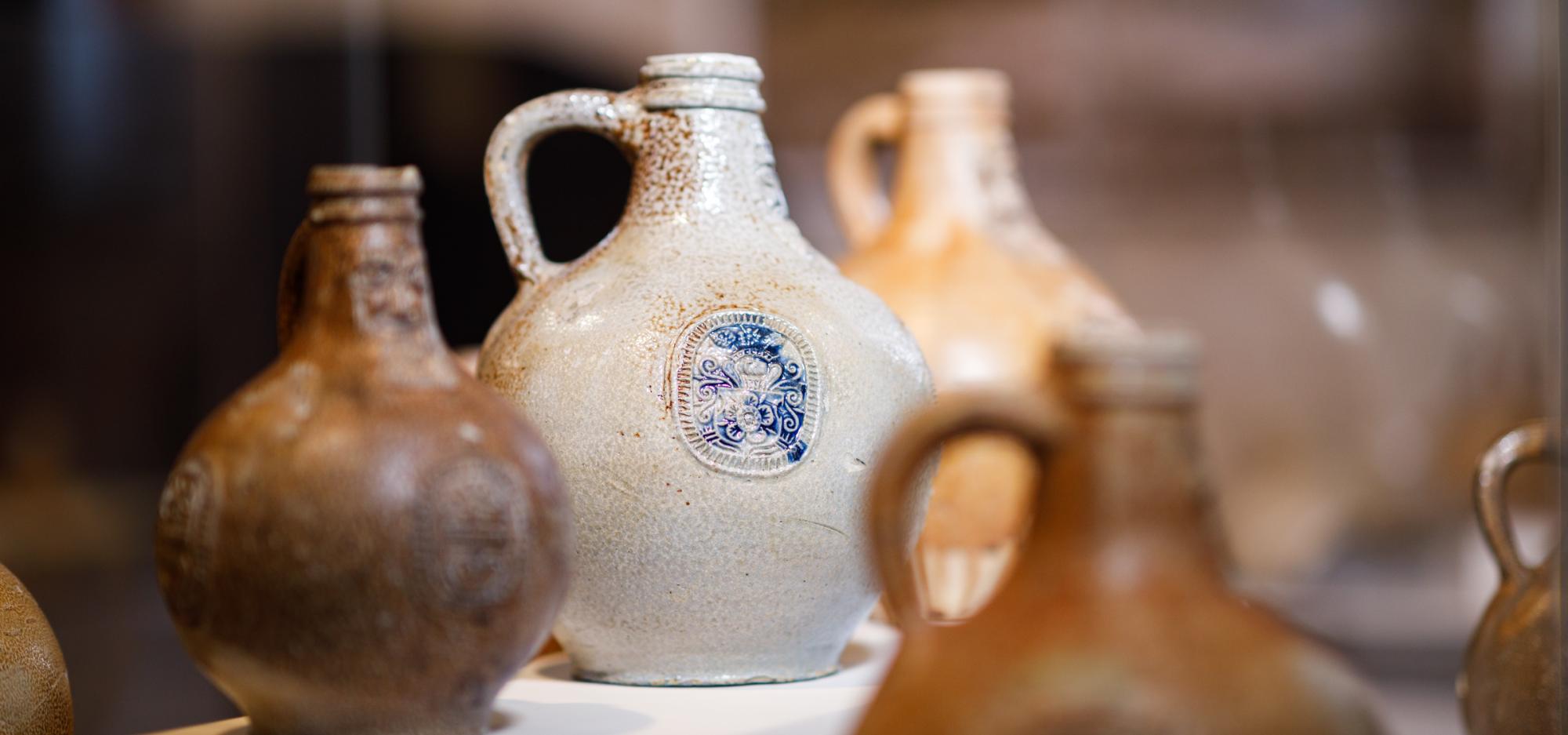 Collection of beige and brown vases with handles