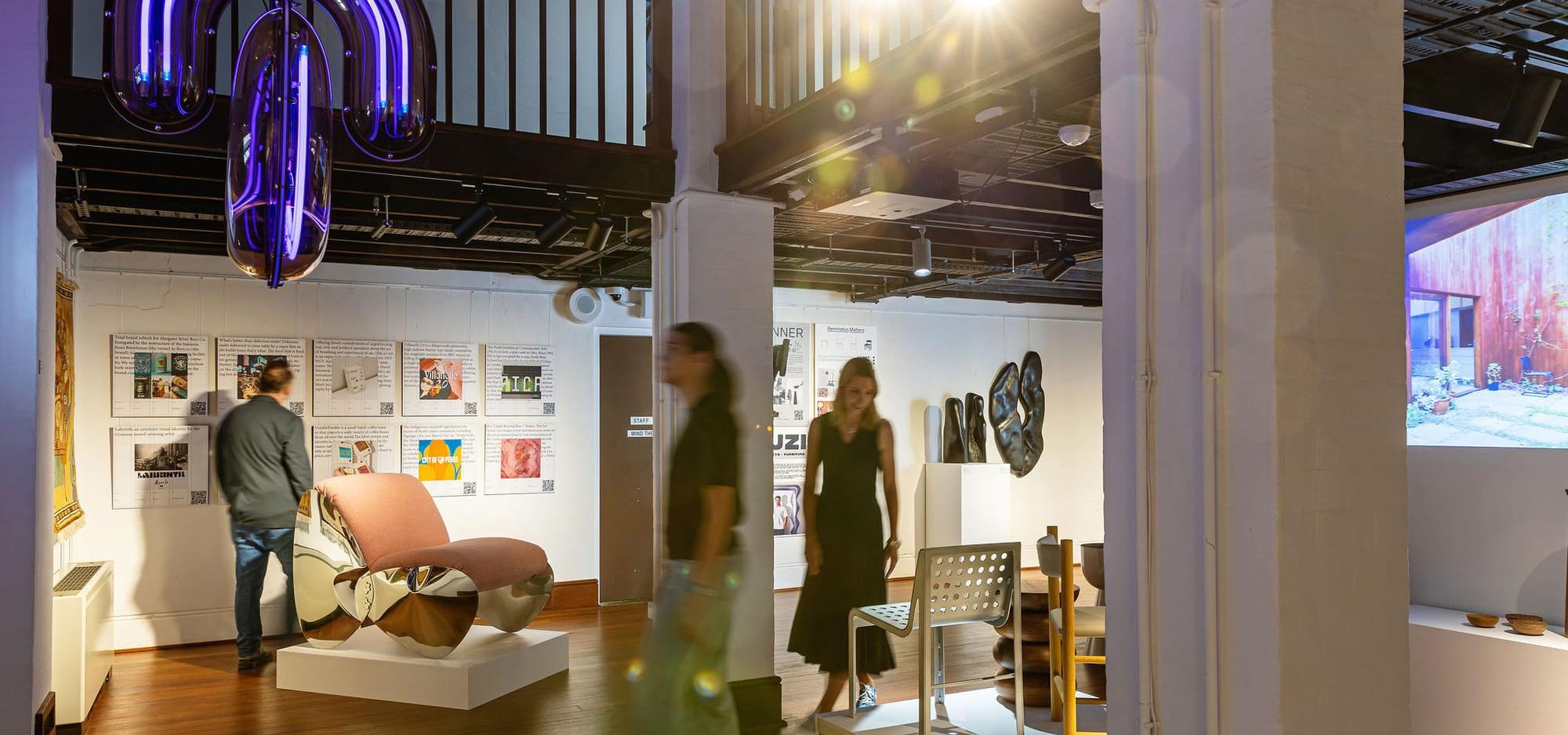 People walking through an architecture exhibition 