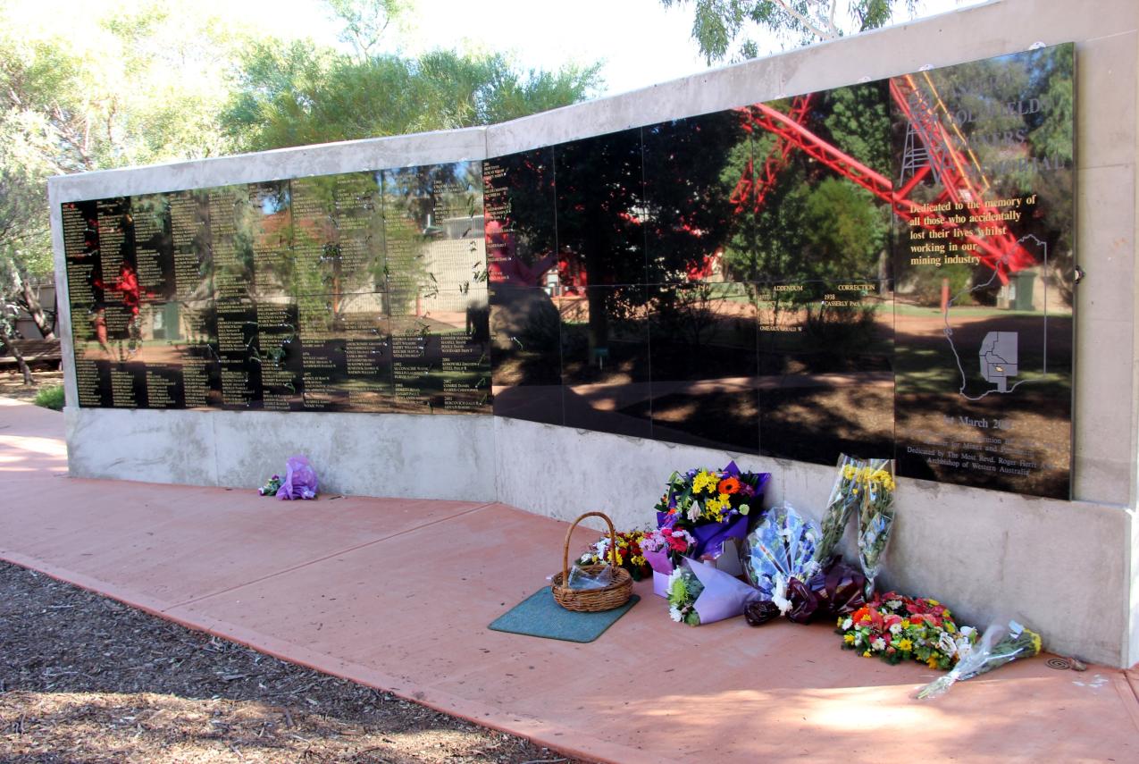 A large memorial with flowers at its base