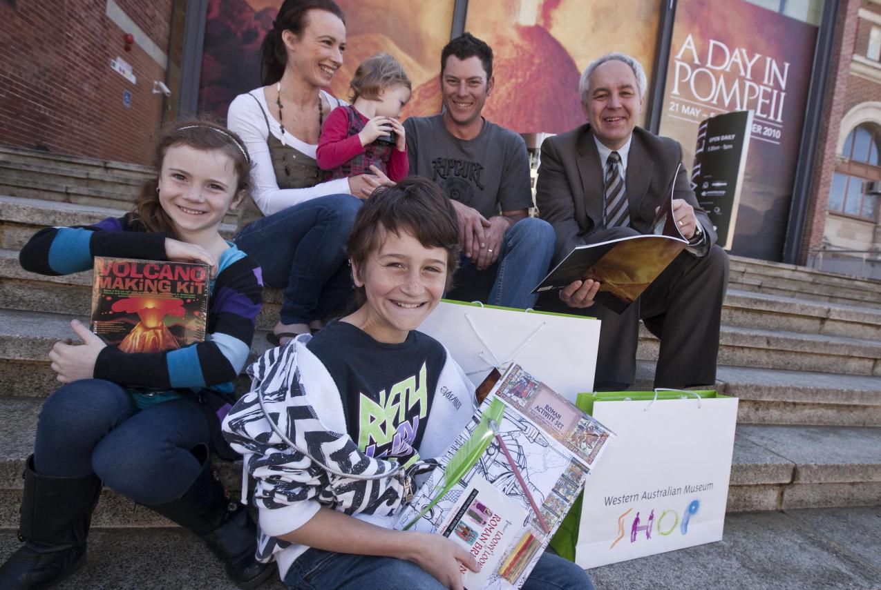 A family with Museum CEO Alec Coles celebrating the 100,000th visitor to the exhibition
