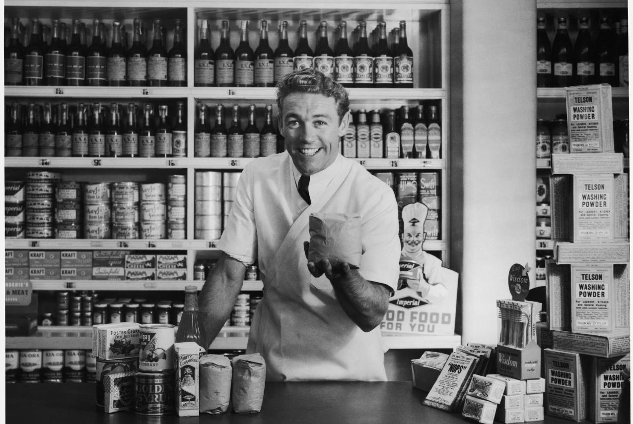 A shop grocer excitedly dealing with a customer